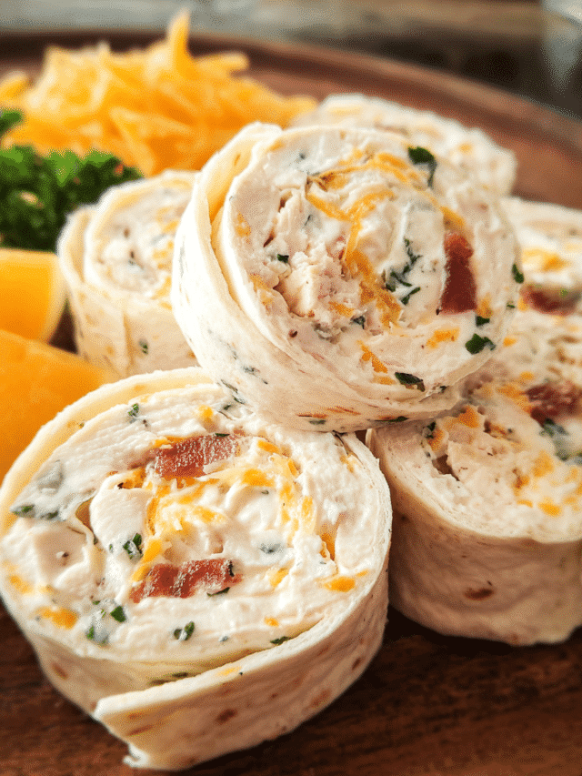 Creamy chicken ranch tortilla rolls sliced into pinwheels on a serving platter