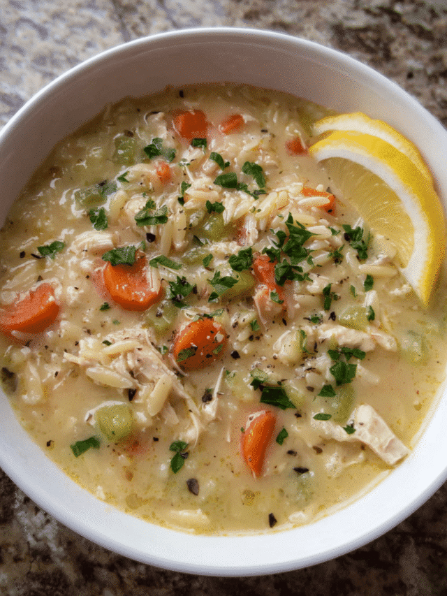 Creamy Parmesan Chicken Orzo Soup served in a white bowl with parsley and parmesan