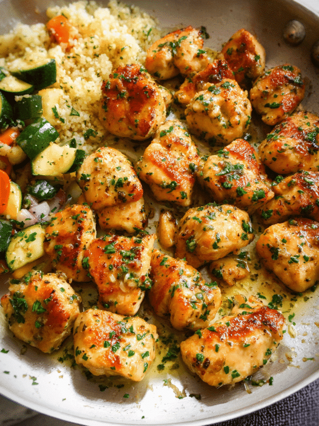 Golden mini garlic butter chicken bites in a skillet with fresh parsley