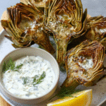 Air fryer artichokes served with creamy feta yogurt dip