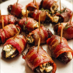Bacon-wrapped dates stuffed with goat cheese on a serving platter