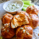 Golden buffalo chicken pretzel bites served with blue cheese dressing