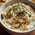 Creamy caramelized onion dip served with chips
