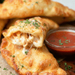 Golden crispy Chicken Alfredo Air Fryer Calzones with garlic butter topping