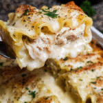 Chicken Alfredo lasagna roll ups baked with melted mozzarella and Alfredo sauce