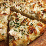 Chicken bacon ranch pizza with melted mozzarella, chicken, and crispy bacon