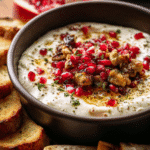Christmas feta dip with pomegranate seeds, candied nuts, and honey drizzle