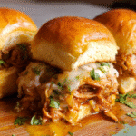 Easy Chicken Birria Sliders with melted cheese and dipping sauce