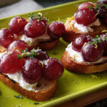 Roasted grape and ricotta crostini served on toasted baguette slices