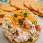 Ultimate Loaded Garlic Chicken Dip served in a bowl with chips