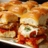 cheesy baked chicken parm sliders in casserole dish