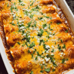 Cheesy chicken enchiladas baked with melted cheese