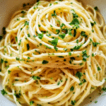 Creamy garlic butter noodles in a bowl with parsley