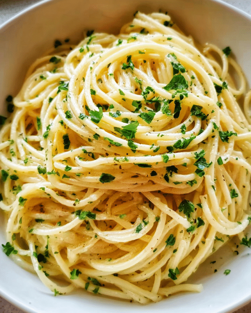 Creamy garlic butter noodles in a bowl with parsley