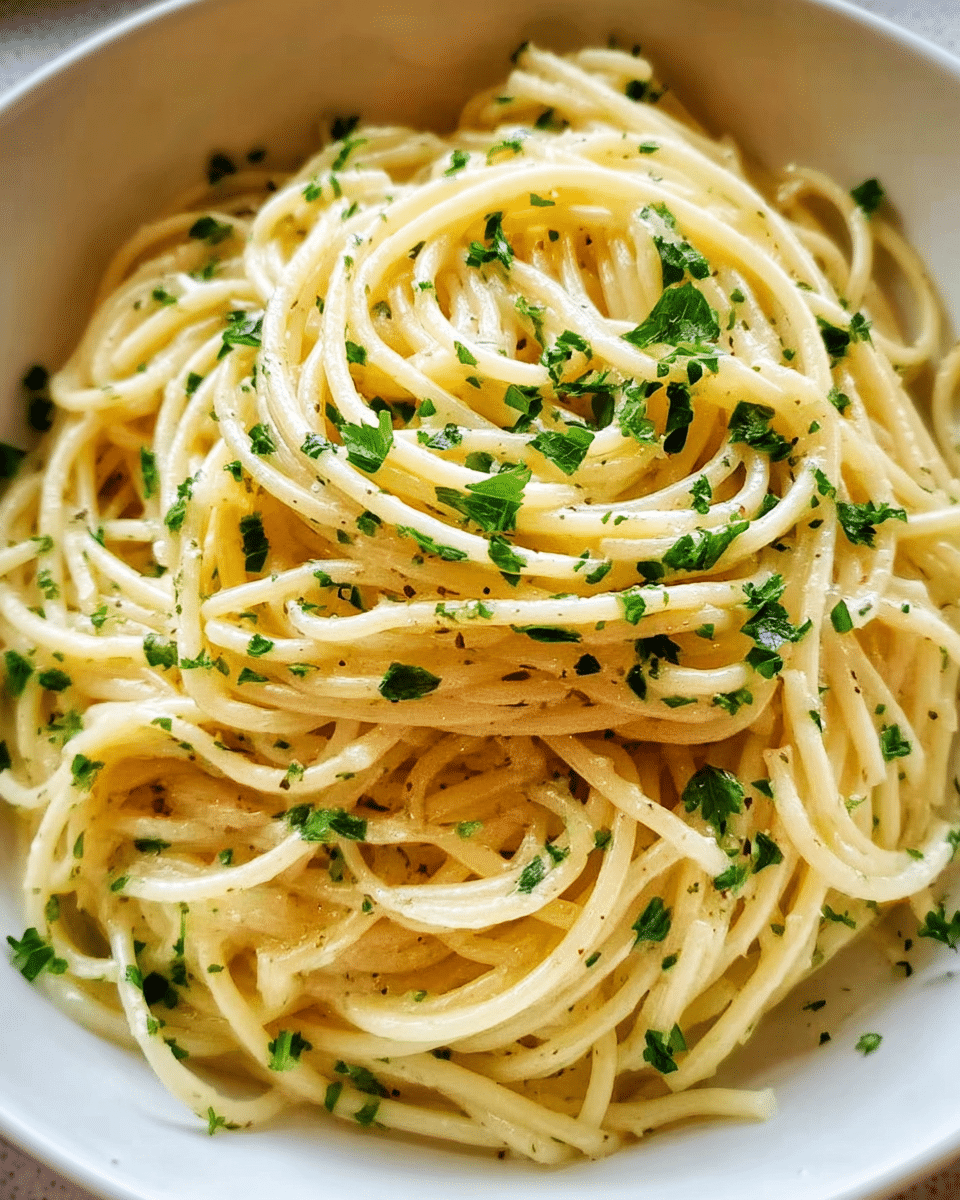Creamy garlic butter noodles in a bowl with parsley