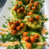 Avocado cucumber bites topped with roasted chickpeas and fresh herbs