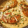 Creamy garlic chicken in a skillet with rich sauce and parsley garnish