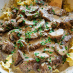 Creamy beef stroganoff with mushrooms served over egg noodles