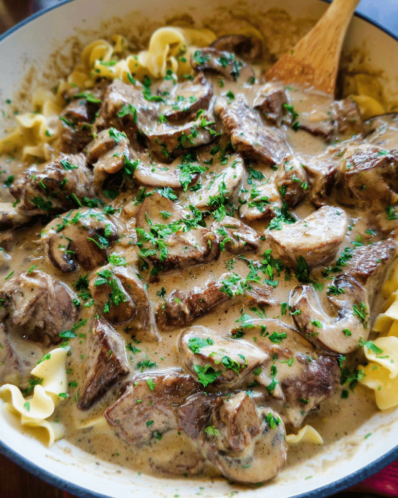 Creamy beef stroganoff with mushrooms served over egg noodles