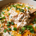 Creamy cheesy jalapeño popper casserole topped with melted cheddar and fresh green onions