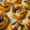 Freshly baked cheesy spinach puffs with flaky puff pastry and creamy spinach filling