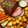 Classic Sunday roast with beef, crispy potatoes, carrots, and gravy