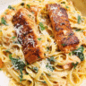 Creamy Cajun salmon pasta served with parmesan cheese and spinach