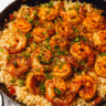 Skillet creamy Cajun shrimp rice garnished with fresh parsley