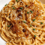 Bowl of creamy caramelized onion pasta with Parmesan and thyme