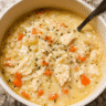 Bowl of creamy chicken rice soup with tender chicken, rice, carrots, and celery