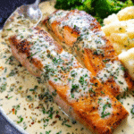 Creamy garlic butter salmon in skillet with sauce