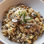 Creamy mushroom wild rice served in a skillet with Parmesan cheese and herbs