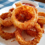 Golden crispy onion rings served fresh with dipping sauce