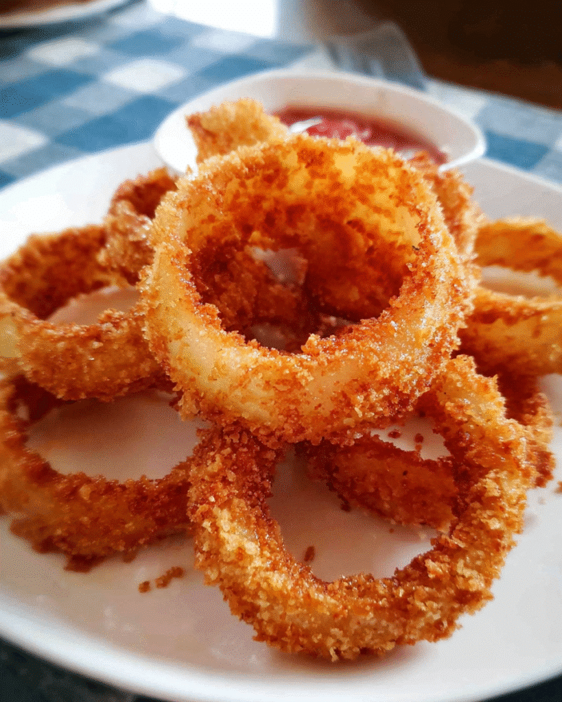 Golden crispy onion rings served fresh with dipping sauce