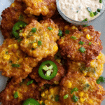 Golden jalapeño corn fritters served with spicy ranch dip