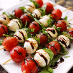 Mini caprese skewers with mozzarella, cherry tomatoes, basil, and balsamic glaze