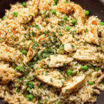 Skillet chicken pot rice with herbs, peas, and tender chicken breast