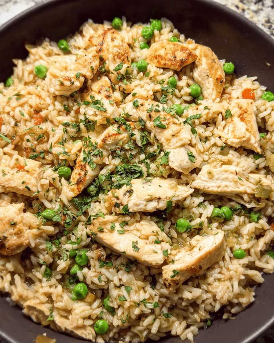 Skillet chicken pot rice with herbs, peas, and tender chicken breast