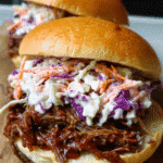 Slow cooker BBQ beef sandwiches topped with fresh coleslaw
