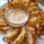 Crispy baked onion petals served with creamy dipping sauce
