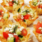 Mediterranean feta bites served in crispy phyllo pastry shells with cucumber tomato filling