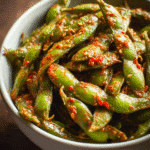 Bowl of spicy garlic edamame coated in savory chili garlic sauce