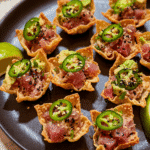Spicy tuna wontons served in crispy baked wonton cups with avocado and jalapeño
